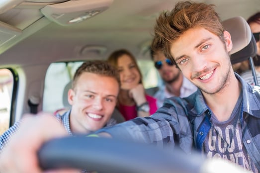 Young people having vacation enjoying fun driving car