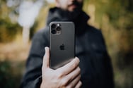 Man in nature holding camera